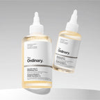 SlimBag Glycolic Acid 7% exfoliating toner bottle for brightening and smoothing skin, with a clear liquid inside and minimalist design
